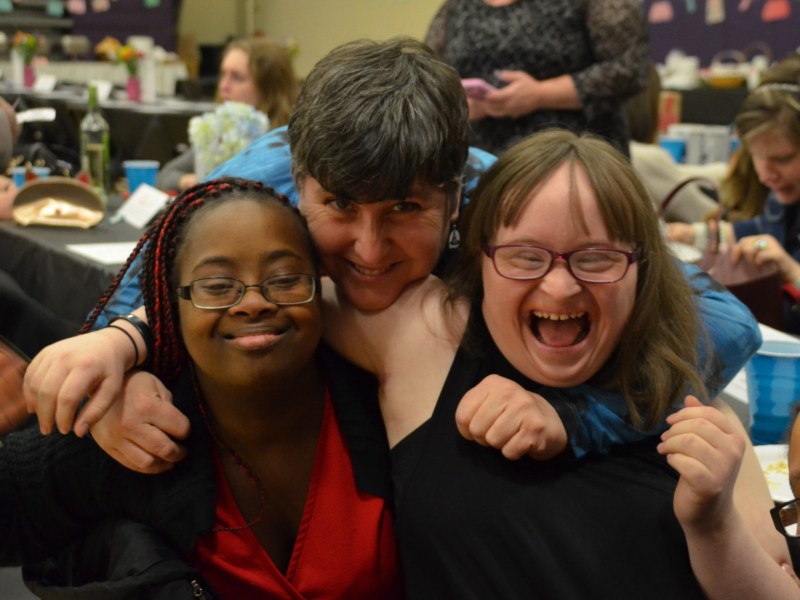 From left to right: Emmaus residents Sidria, Cece and Carah attend an Emmaus Community Night.