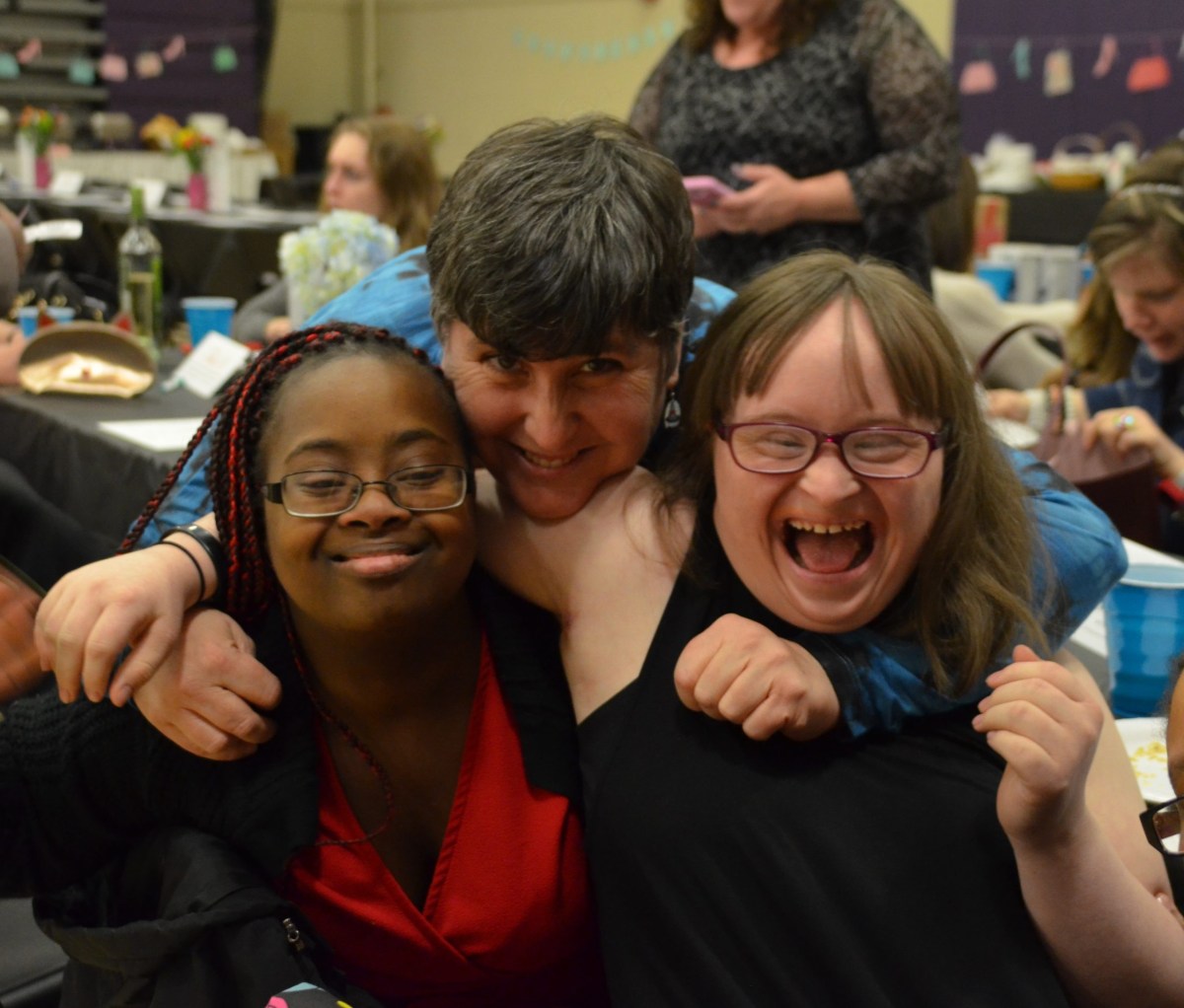 From left to right: Emmaus residents Sidria, Cece and Carah attend an Emmaus Community Night.