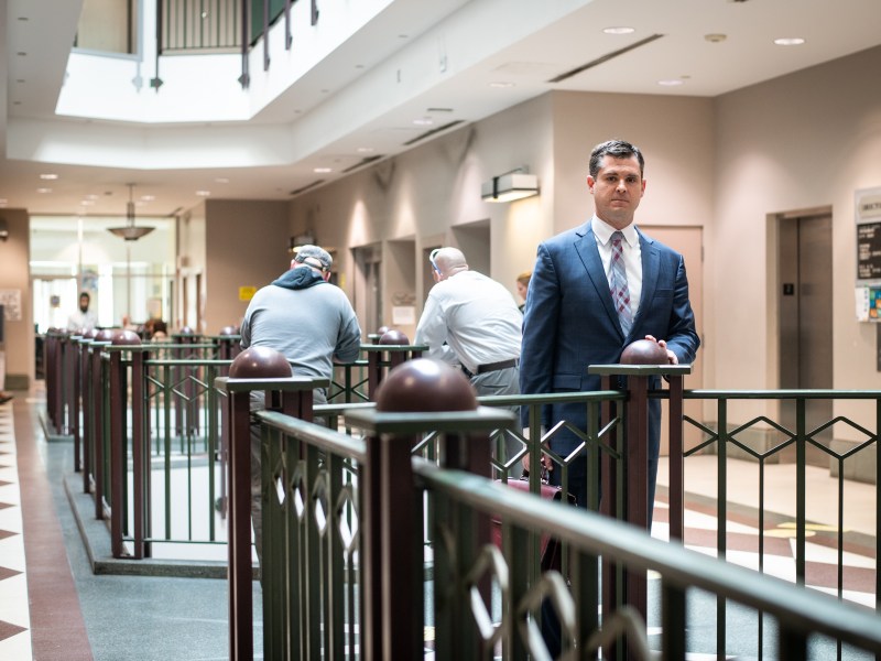 Rob Perkins, an attorney who has does some court-appointed work, stands for a portrait in the Pittsburgh Municipal Court on Tuesday, April 11, 2023, Downtown. Perkins has been a proponent in the fight for fairer attorney compensation. (Photo by Stephanie Strasburg/PublicSource)