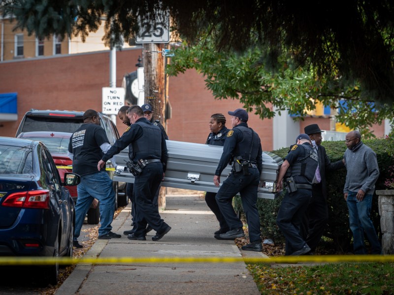 Police carry a casket to a hearse from the Destiny of Faith Church on Friday, Oct. 28, 2022, in Brighton Heights. The funeral of John Hornezes Jr., one of the victims in the Cedar Avenue shooting on Oct. 15, was taking place as multiple shooters shot into the crowd gathered outside the church, hitting six people. (Photo by Stephanie Strasburg/PublicSource)