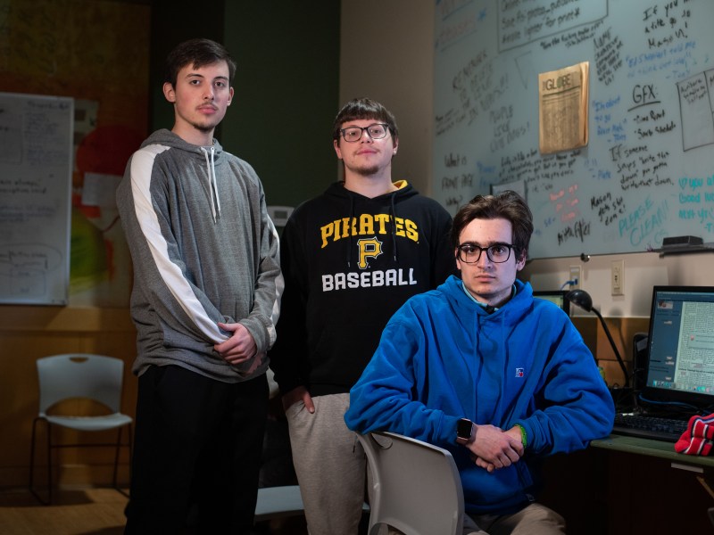 From left, Point Park University students Mason Strawn, Antonio Rossetti and Jake Dabkowski pause their work on the student-run paper to pose for a portrait in the Point Park Globe’s on-campus newsroom, Monday, Nov. 14, 2022, in downtown Pittsburgh. The student journalists shared their thoughts on how male-identifying students can play a role in preventing sexual assault on campus. (Photo by Stephanie Strasburg/PublicSource) #RedZone