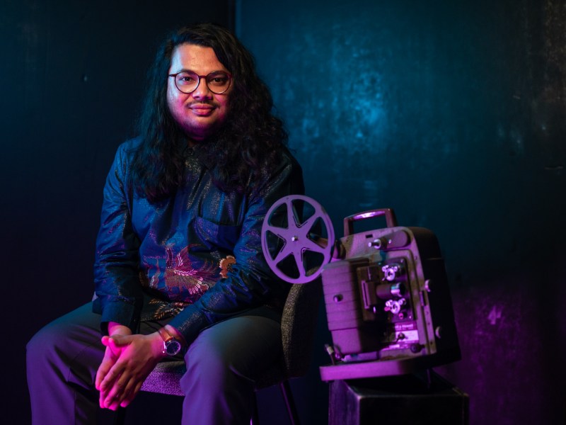 Arko Dasgupta, a graduate student at Carnegie Mellon University, sits for a portrait on Wednesday, Jan. 4, 2023, in the Strip District. Dasgupta taught a class on Indian cinema over the previous summer, spurring conversations about culture among his students. (Photo by Stephanie Strasburg/PublicSource)