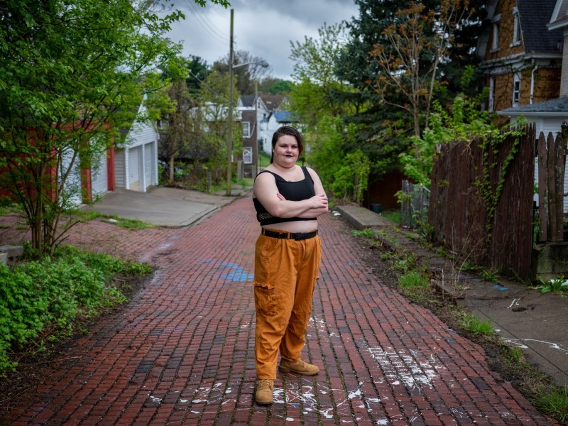 Faith Muse, a former Community College of Allegheny County [CCAC] student who left in fall 2020, stands for a portrait on Sunday, April 30, 2023, in their neighborhood of Allentown. Muse is one of more than 5,500 people who have left CCAC during the pandemic. (Photo by Stephanie Strasburg/PublicSource)