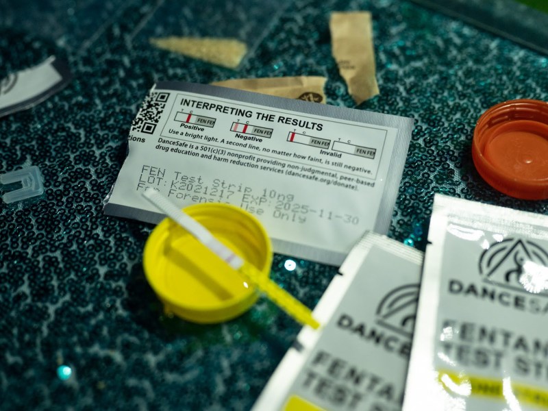 A fentanyl test strip on display at a rave on Saturday, March 4, 2023, in the Pittsburgh area. Two pink lines indicating a negative test for fentanyl. Drug consumers can then make more informed decisions about what to do with the substance from there. (Photo by Stephanie Strasburg/PublicSource)