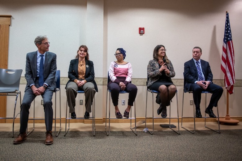 Democratic candidates for Allegheny County executive debate at a forum hosted by Democratic and grassroots groups on Wednesday night, Feb. 15, 2023, at the Hampton Community Center. Seated from left are Dave Fawcett, Erin McClelland, Liv Bennett, Sara Innamorato and Michael Lamb. John Weinstein did not join until later in the event. (Photo by Stephanie Strasburg/PublicSource)