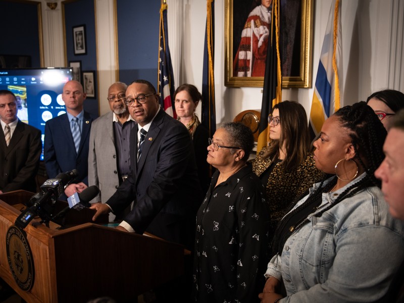 Mayor Ed Gainey, center, takes the podium surrounded by elected officials to answer questions about challenging the tax-exempt status of 26 Pittsburgh properties in a press conference at his office on Tuesday, March 28, 2023, in the City-County Building in Downtown. The push is part of a new legal strategy to root out tax-exempt properties in Pittsburgh that shouldn’t qualify for exemption under Pennsylvania law. (Photo by Stephanie Strasburg/PublicSource)