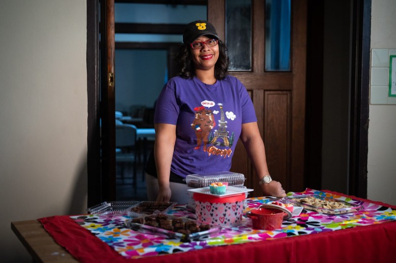 Violet Scott of Veez Decadent Brownies stands for a portrait with some of her baked goodies in the commercial kitchen in St. Stephen’s Episcopal Church where she bakes for her business on April 12, 2023, in Wilkinsburg. (Photo by Stephanie Strasburg/PublicSource)