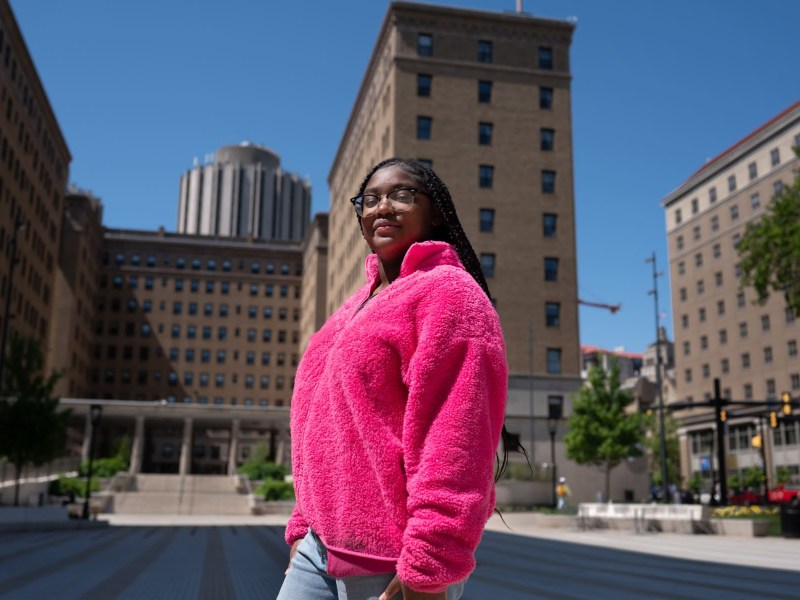 Ciara Gordon, a University of Pittsburgh student with ambitions of being a pediatrician, sits for a portrait in a Pitt classroom on Wednesday, May 17, 2023, in Oakland. Gordon, originally from Homewood, received enough scholarships and grants to make her education at Pitt possible. She was involved in some of Pitt's advocacy efforts to maintain its in-state tuition discount last year. (Photo by Stephanie Strasburg/PublicSource)