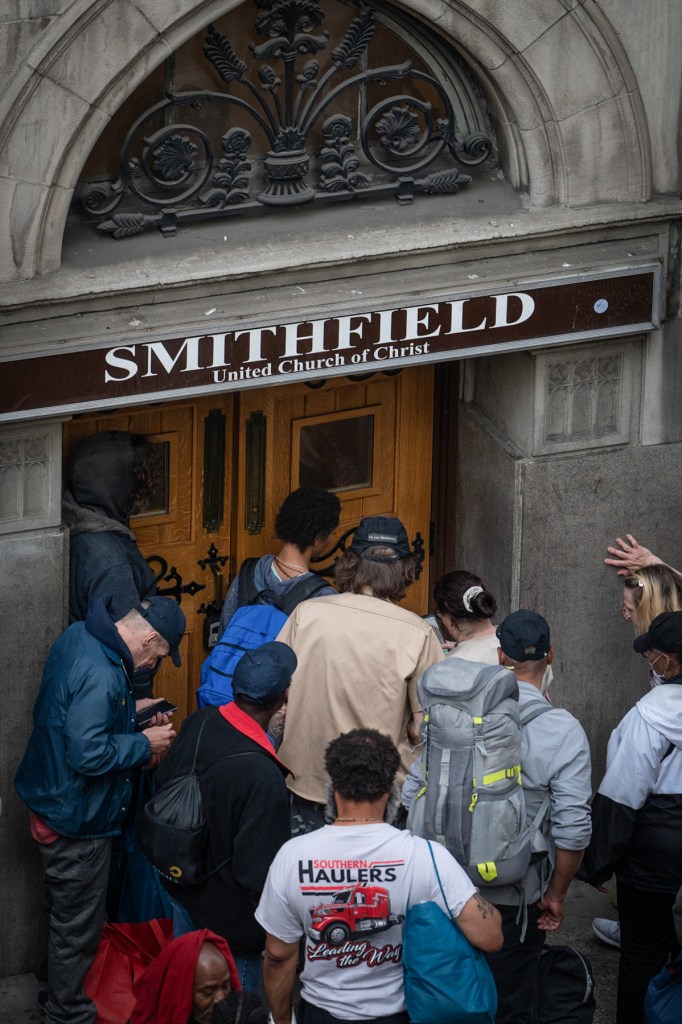 People wait to get into the Smithfield United Church of Christ shelter on the evening of May 22, 2023, when Allegheny County Department of Human Services announced that it would close the downtown Pittsburgh space in June. (Photo by Stephanie Strasburg/PublicSource)