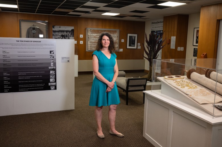 Emily Loeb, director of programs and education at the Holocaust Center of Pittsburgh, at the center’s “Revolving Doors” exhibit at Chatham University’s Jennie King Mellon Library, on Wednesday, Aug. 16, 2023, in Squirrel Hill North. (Photo by Stephanie Strasburg/PublicSource)