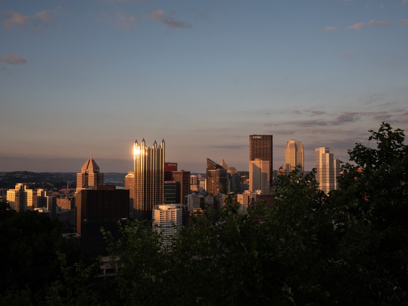 Pittsburgh’s downtown skyline is illuminated by the setting sun on Tuesday, Sept. 5, 2023, as seen from Mt. Washington. (Photo by Stephanie Strasburg/PublicSource)