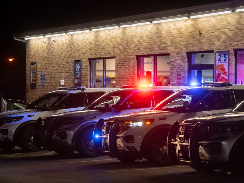 Police cars line the parking lot of a South Side gas station following a high school football game on Sept. 21, 2023. (Photo by Stephanie Strasburg/PublicSource)