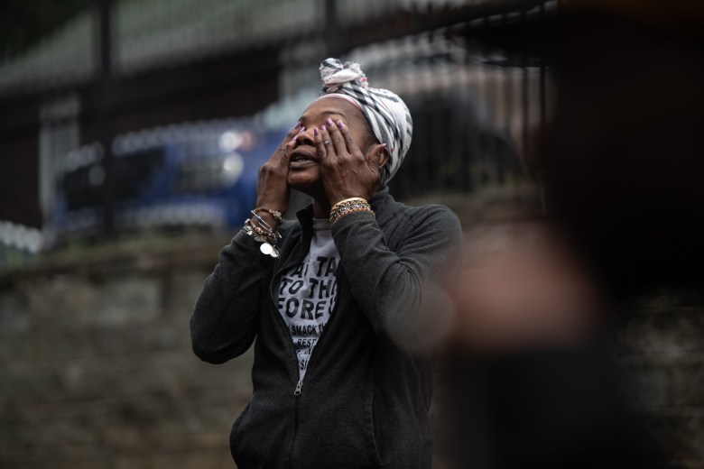 Hi View Gardens tenant Keisharra Abercrombie covers her face with her hands and tilts her head to the sky as becomes emotional at a tenant council meeting outside Hi View on Tuesday, Sept. 26, 2023, in McKeesport. “I’m ready to go,” said Abercombie, a resident for seven months at the apartment complex who lives there with her son, who is deaf. (Photo by Stephanie Strasburg/PublicSource)