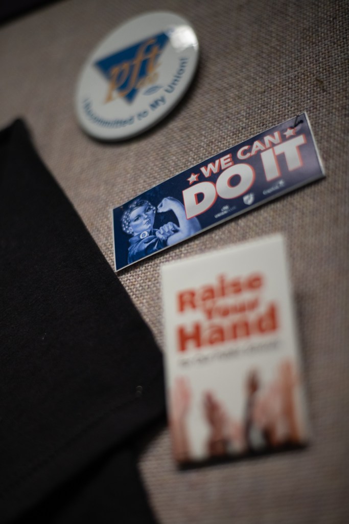 Pins from past campaigns hang on the cubicle walls at the Pittsburgh Federation of Teachers union offices in the South Side Flats on Thursday, Oct. 19, 2023. "We can do it" reads an all-caps rectangle with Rosie the Riveter showing her signature muscle. (Photo by Stephanie Strasburg/PublicSource)