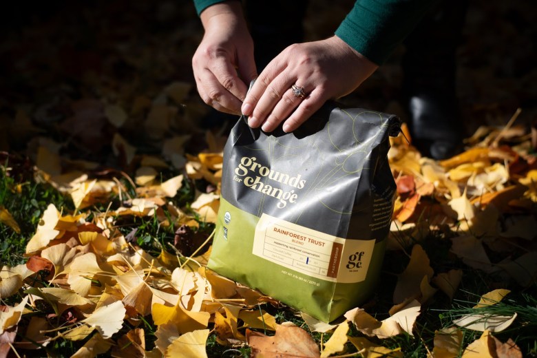 Melanie Linn Gutowski seals her bag of Grounds for Change coffee, on Nov. 3, 2023, at her home in Sharpsburg. She bulk-buys the coffee which is from a family-owned, certified organic processing company that is also carbon-free certified. (Photo by Stephanie Strasburg/PublicSource)