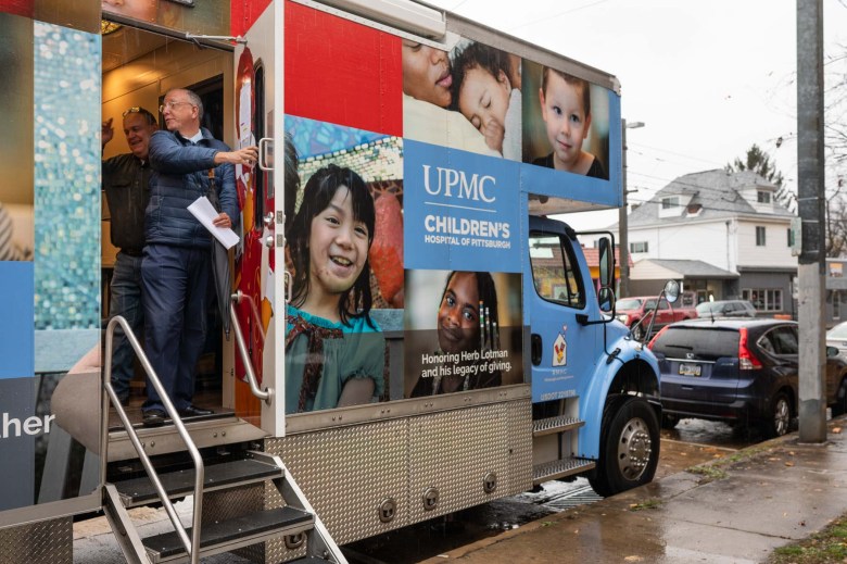 Two people leave the mobile care truck.