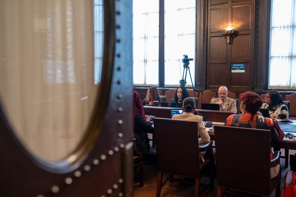 A group of people sitting in a conference room.