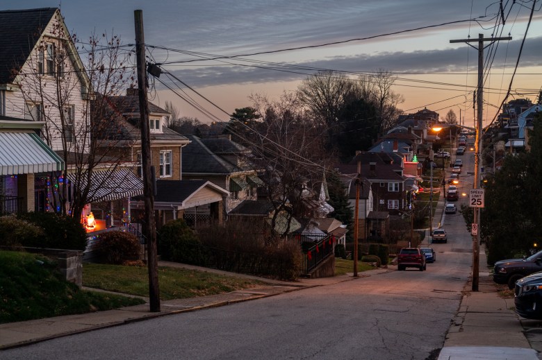 A residential street under an evening sky.