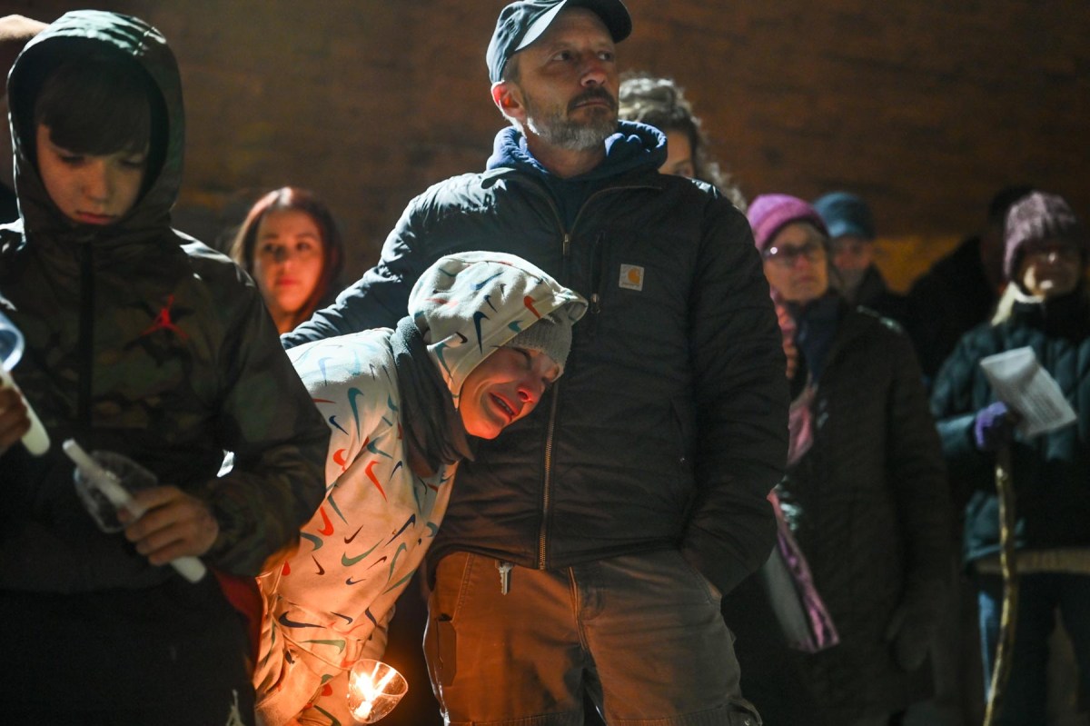 Dave Lettrich, executive director of the street outreach group Bridge to the Mountains, comforts Caydee, a woman experiencing homelessness, on Dec. 21 during a Downtown candlelight vigil, organized by Pittsburgh Mercy’s Operation Safety Net, to remember 23 people known to have died while unhoused in Pittsburgh in the past year. The previous year, there were 13. Homelessness is now "at a different level of crisis, and we’re going to have to figure out who we are – maybe before we really figure out what to do,” said Dr. Jim Withers, founder of the Street Medicine Institute. (Photo by Stephanie Strasburg/PublicSource)