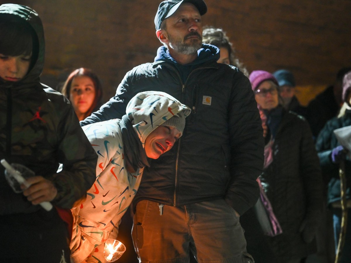 Dave Lettrich, executive director of the street outreach group Bridge to the Mountains, comforts Caydee, a woman experiencing homelessness, on Dec. 21 during a Downtown candlelight vigil, organized by Pittsburgh Mercy’s Operation Safety Net, to remember 23 people known to have died while unhoused in Pittsburgh in the past year. The previous year, there were 13. Homelessness is now "at a different level of crisis, and we’re going to have to figure out who we are – maybe before we really figure out what to do,” said Dr. Jim Withers, founder of the Street Medicine Institute. (Photo by Stephanie Strasburg/PublicSource)