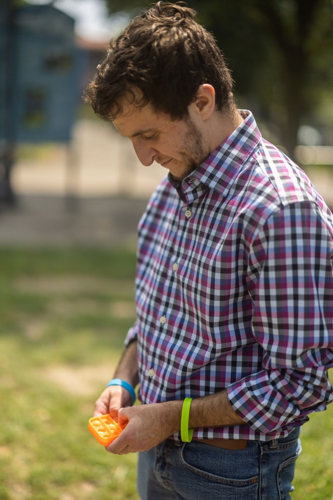 Eli uses one of the fidget toys that he keeps attached to his belt loop. (Photo by Benjamin Brady/PublicSource)