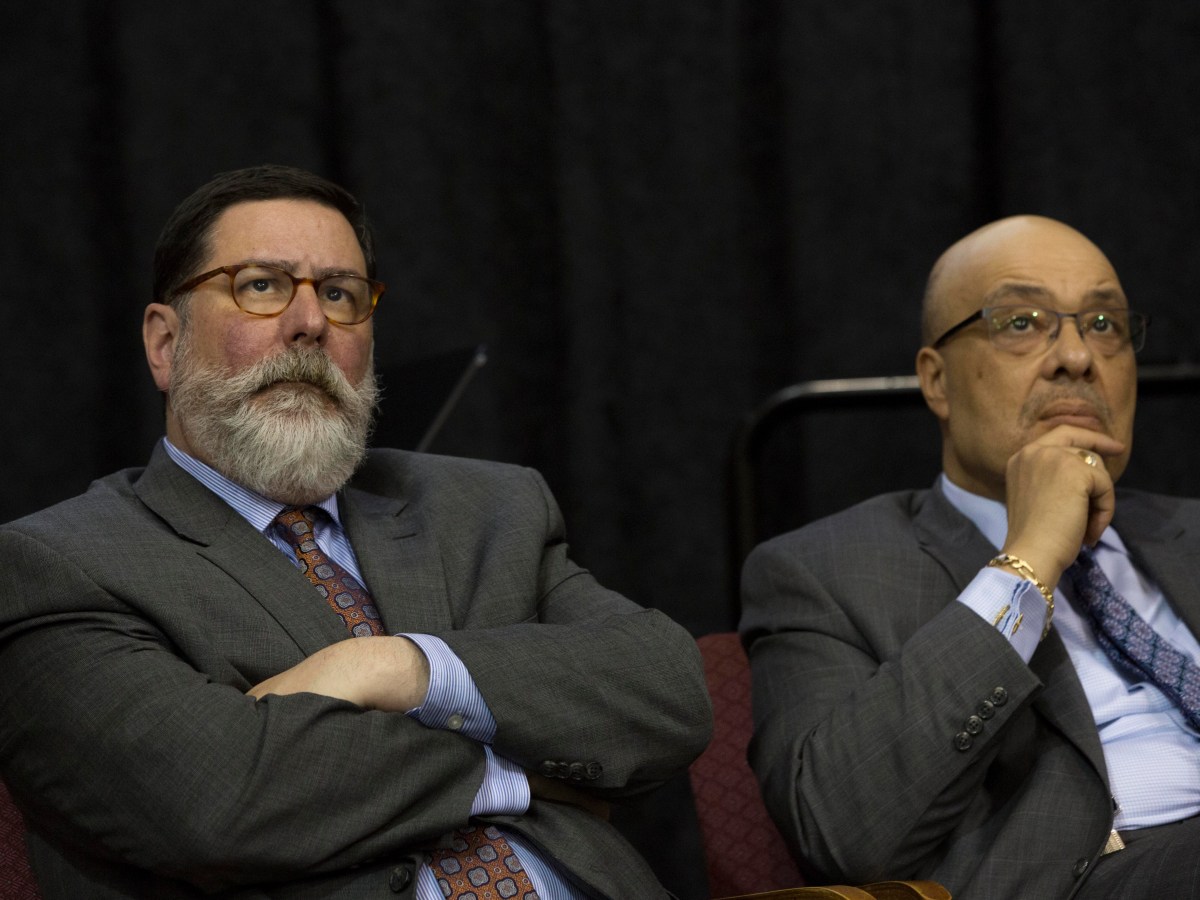 Pittsburgh Mayor Bill Peduto and City Councilman Rev. Ricky Burgess sit and listen to a 2019 presentation of the Homewood Comprehensive Community Plan. Burgess later sponsored, and Peduto signed, legislation creating the Commission on Racial Equity. (Photo by Heather Mull/PublicSource)