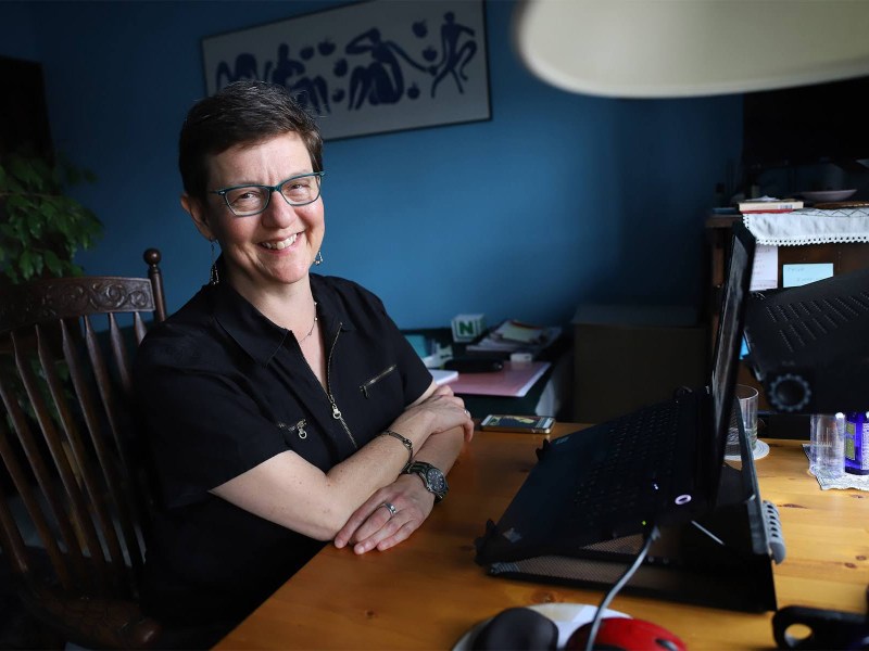 Allegra Elson sitting at her desk at home with a computer in front of her.