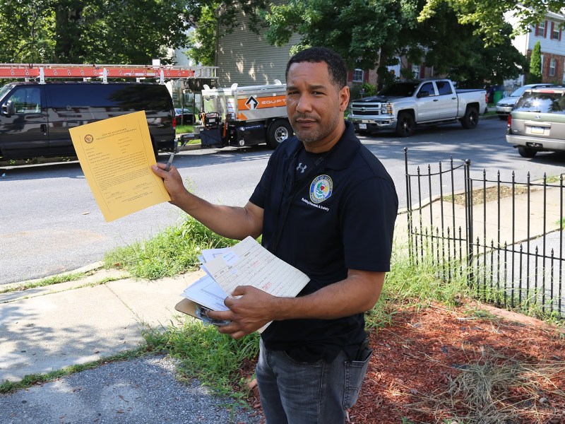 City of Allentown Housing Inspector Modesto Medina shows an example of the certificate property owners receive when their buildings pass inspection. Unlike Allentown and Erie, Pittsburgh has no routine rental unit inspection program. (Photo by Rich Lord/PublicSource)