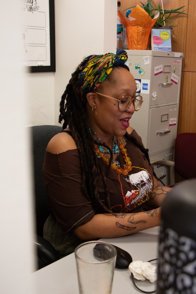 Amber Edmunds sitting at her desk typing on a computer.