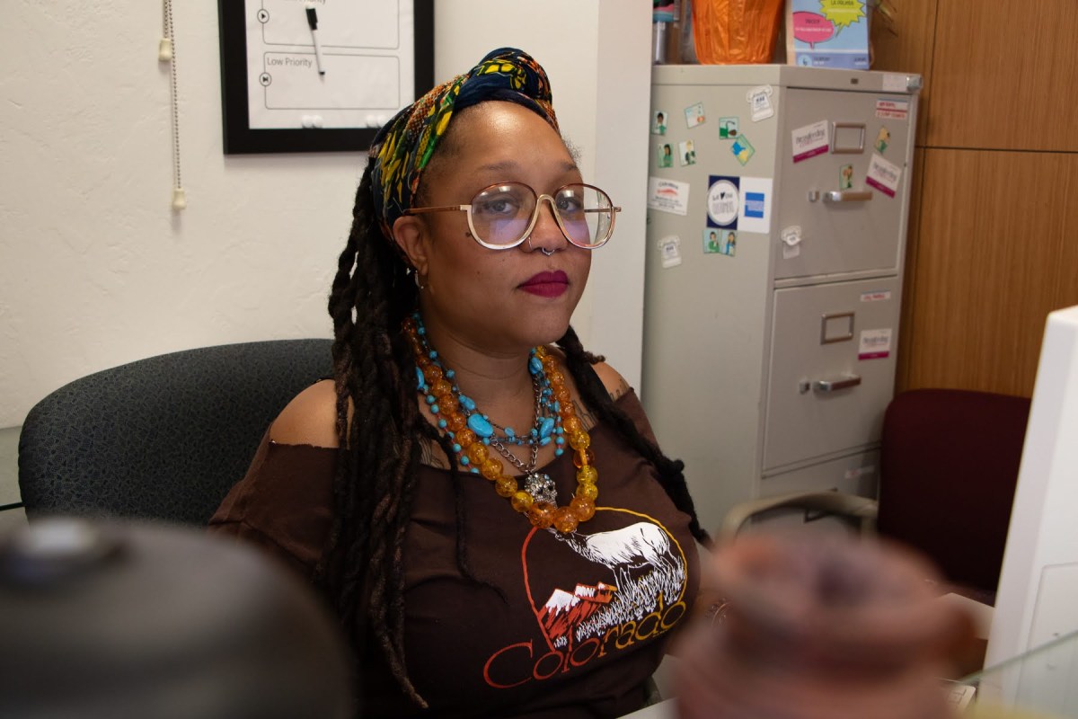 Amber Edmunds at her desk at the MAYA Organization offices in Swissvale on July 12, 2023. As the executive director of MAYA Organization, Edmunds works to challenge the lack of support that society provides to Black mothers. (Photo by Alexis Wary/PublicSource)