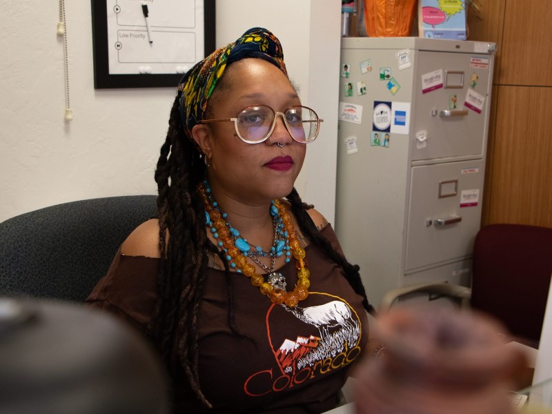 Amber Edmunds at her desk at the MAYA Organization offices in Swissvale on July 12, 2023. As the executive director of MAYA Organization, Edmunds works to challenge the lack of support that society provides to Black mothers. (Photo by Alexis Wary/PublicSource)