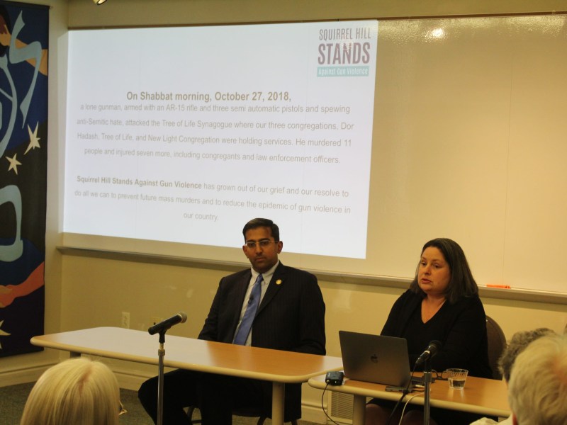 State Rep. Arvind Venkat, left, and Policy Director Dana Kellerman of Squirrel Hill Stands Against Gun Violence address an audience at the anti-gun-violence group's event at Congregation Rodef Shalom in Squirrel Hill North on May 10, 2023. The slide show reflected the proximity in time of the trial of the accused shooter in a 2018 massacre that killed 11 worshipers of other Squirrel Hill congregations. (Photo by Matt Petras/PublicSource)