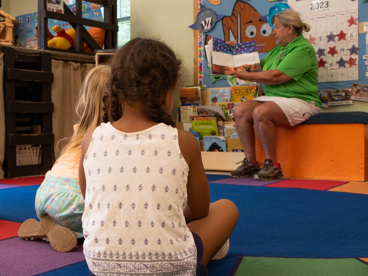 Children at Mount Washington Children's Center sit for storytime with director Rose Marie Smith. (Photo by Alexis Wary/PublicSource)