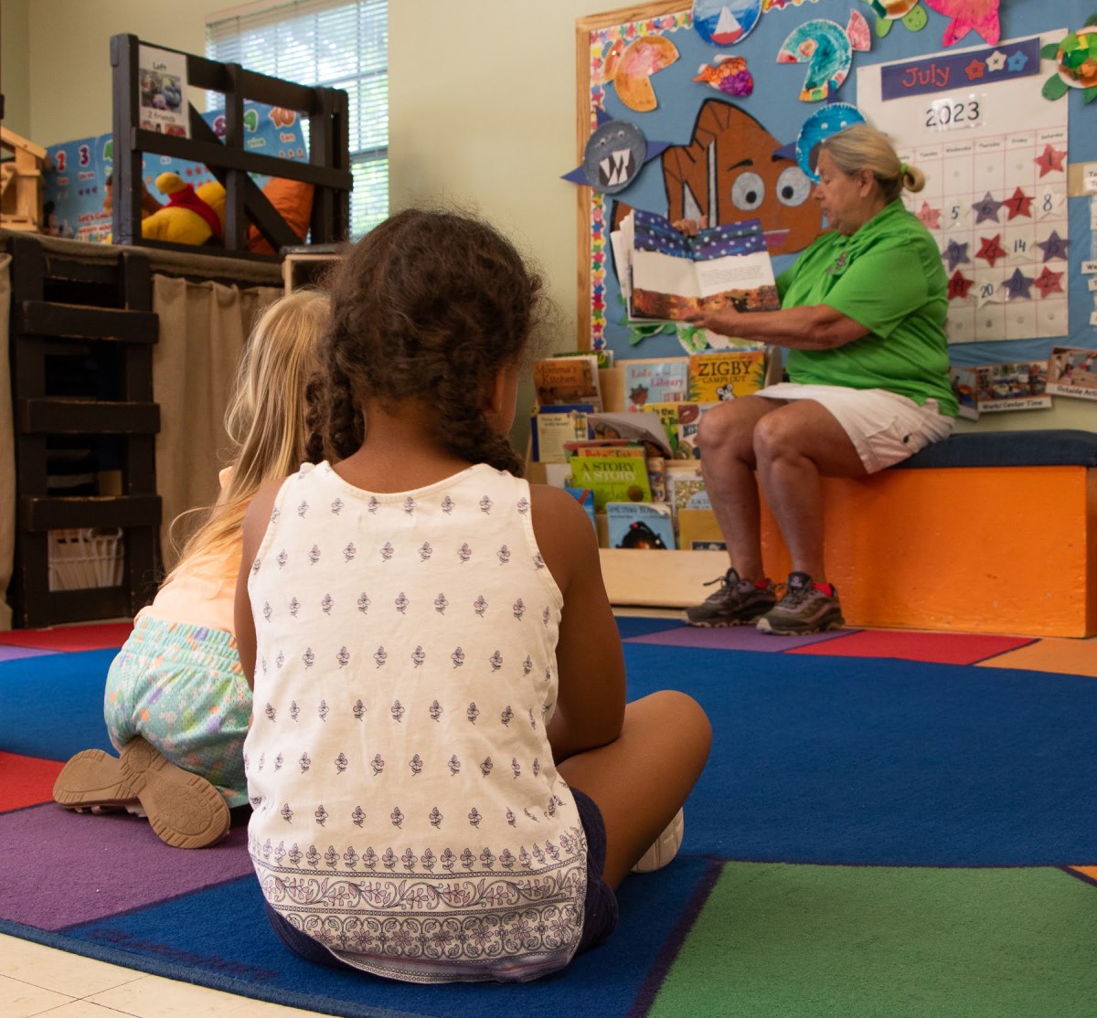 Children at Mount Washington Children's Center sit for storytime with director Rose Marie Smith. (Photo by Alexis Wary/PublicSource)