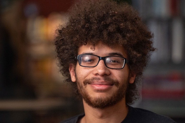 PublicSource intern Dakota Castro-Jarrett sits for a portrait on Thursday, Jan. 26, 2023, in the organization’s Uptown newsroom. (Photo by Stephanie Strasburg/PublicSource)