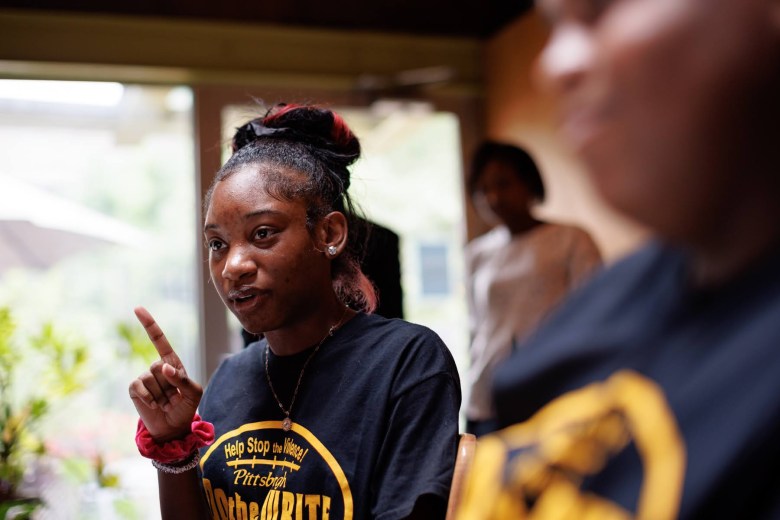 Jaia Harrison, a freshman at Northgate Senior High School, talks about her essay calling for attention to youth mental health and her subsequent involvement in the Do the Write Thing program, at the PublicSource office in Uptown Pittsburgh on Aug. 5, 2022, with fellow youth ambassador Deahmi Mobley. (Photo by Quinn Glabicki/PublicSource)