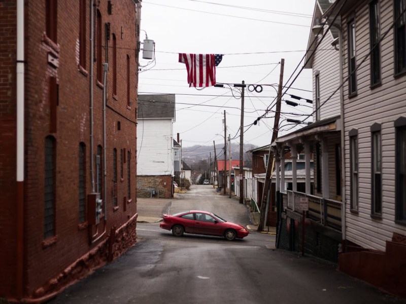 A car travels down South Washington Street in Waynesburg, the largest municipality in Greene county with a population of 4,176. (Photo by John Hamilton/PublicSource)