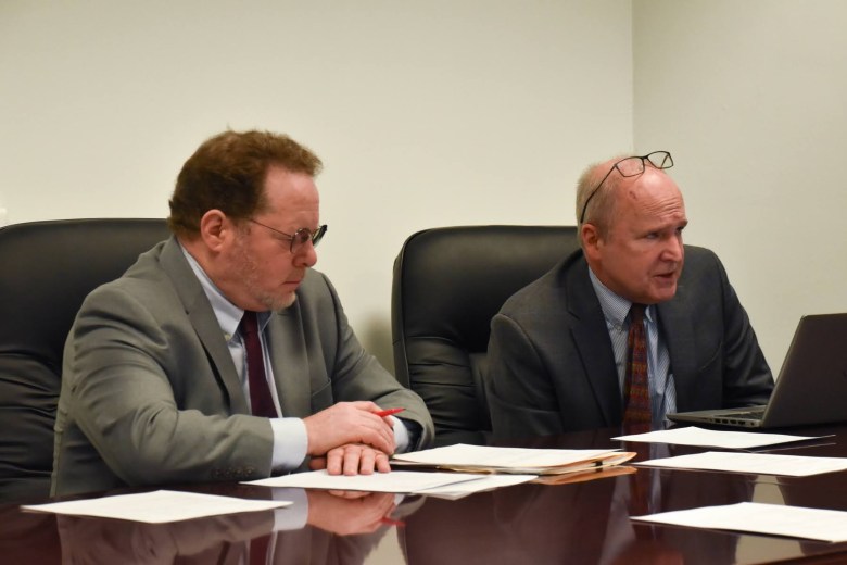 Wayde Fargotstein (left), chair of the Property Assessment Appeals & Review Board, and lawyer David Montgomery discuss county property assessments at a board meeting on Thursday, February 16th, 2023 in the County Office Building in downtown Pittsburgh. The board annually decides thousands of property assessment appeals, and this year faces a unique scenario due to the change in the Common Level Ratio. (Photo by Amaya Lobato-Rivas/PublicSource)