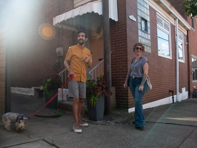 Andy Kelemen and a neighbor chat outside of his home in Central Lawrenceville. Although he rues the general lack of a sense of community in his neighborhood, Andy has met a few neighbors when walking his dog. (Amaya Lobato Rivas/PublicSource)