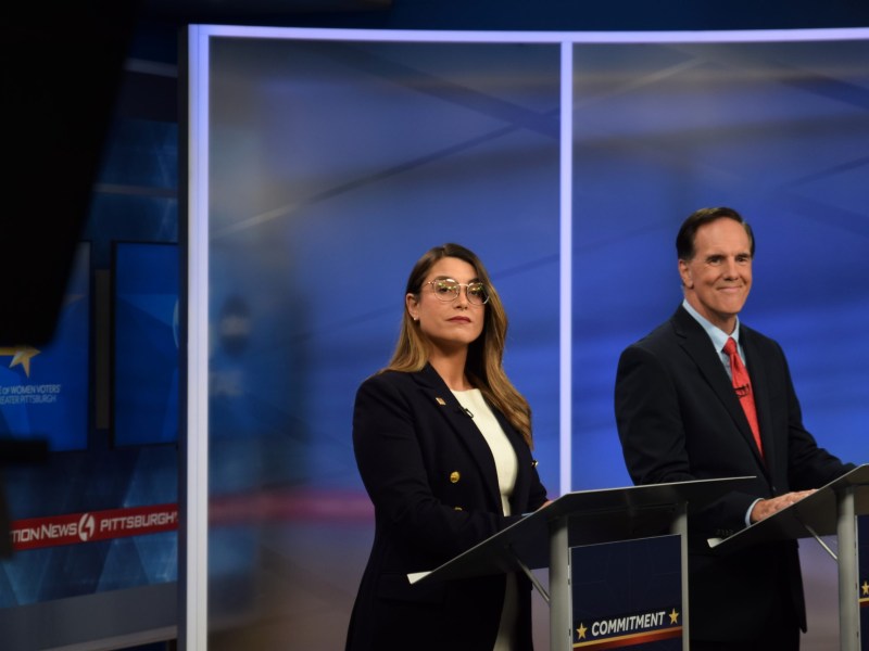 Sara Innamorato and Joe Rockey stand next to each other in a TV studio at podiums.