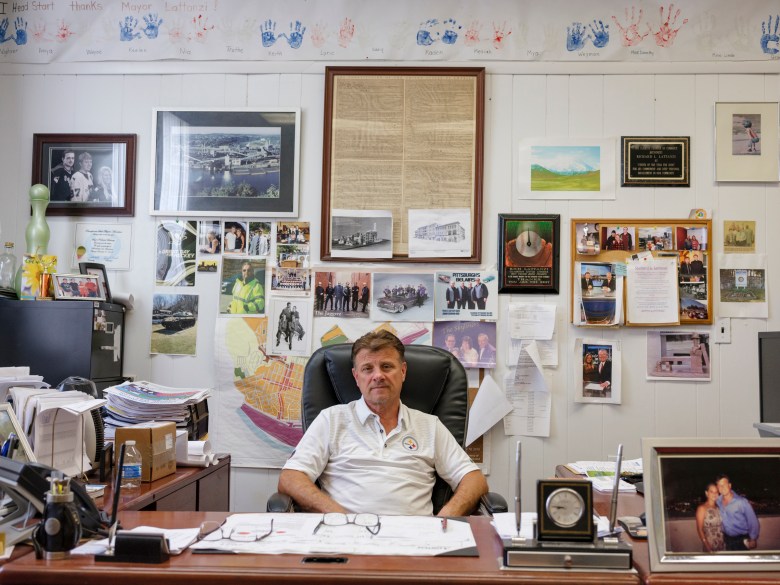 Clairton Mayor Rich Lattanzi sits behind his desk, surrounded by three terms’ worth of memories. He is a former U.S. Steel safety coordinator. Like many former steelworkers, he notes that the air in Clairton is far better than it used to be. “Those hills back there used to be black,” he said outside of a polling location during the primary election in May 2021, gesturing beyond the emissions rising up from the Coke Works and across the river, where green trees line the hilltops.