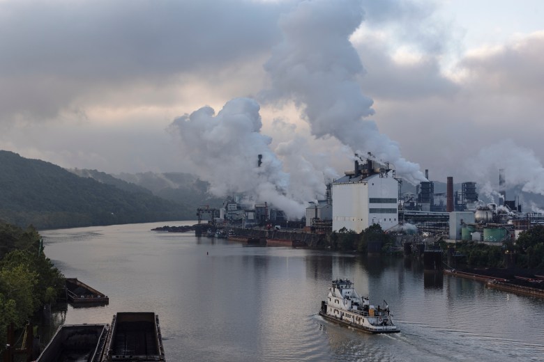 A tugboat passes U.S. Steel’s Clairton Coke Works early in the morning of Sept. 9, 2021. Originally constructed in 1901, the Clairton Coke Works is the largest coke-producing facility in the United States.