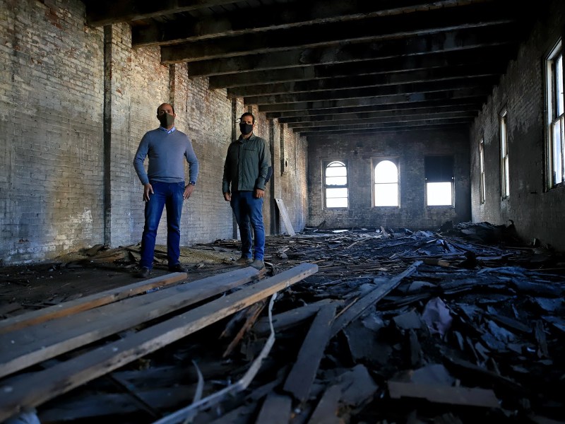 Brothers Michael (left) and Nicholas (right) Troiani in one of their buildings in Downtown Pittsburgh's Firstside district. They say deteriorating brick makes it impossible to save the structures. (Photo by Jay Manning/PublicSource)