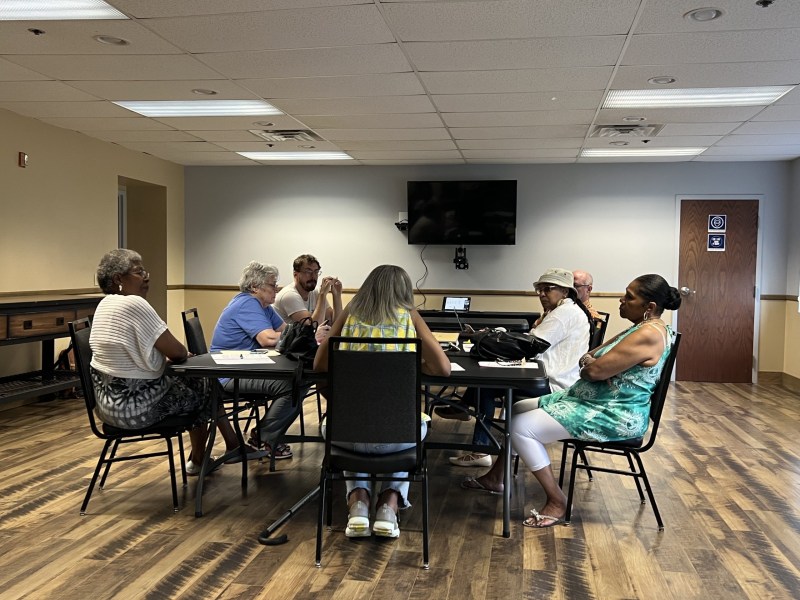 The Wilkinsburg Government Study Commission sits around a table at a July meeting at Hosanna House in Wilkinsburg (Photo by Charlie Wolfson/PublicSource)