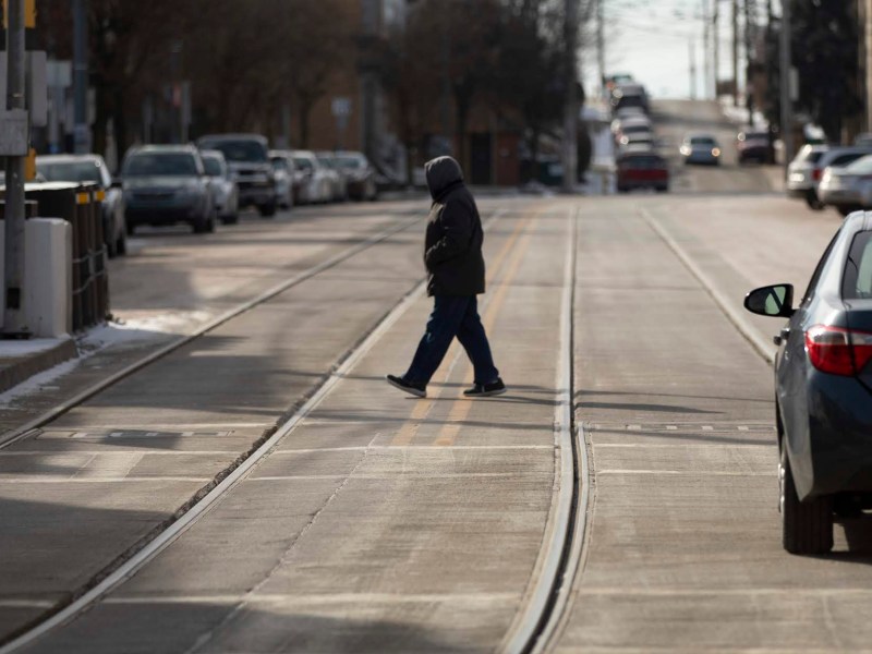 A pedestrian crosses the street in Beechview. (Photo by Kat Procyk/PublicSource)