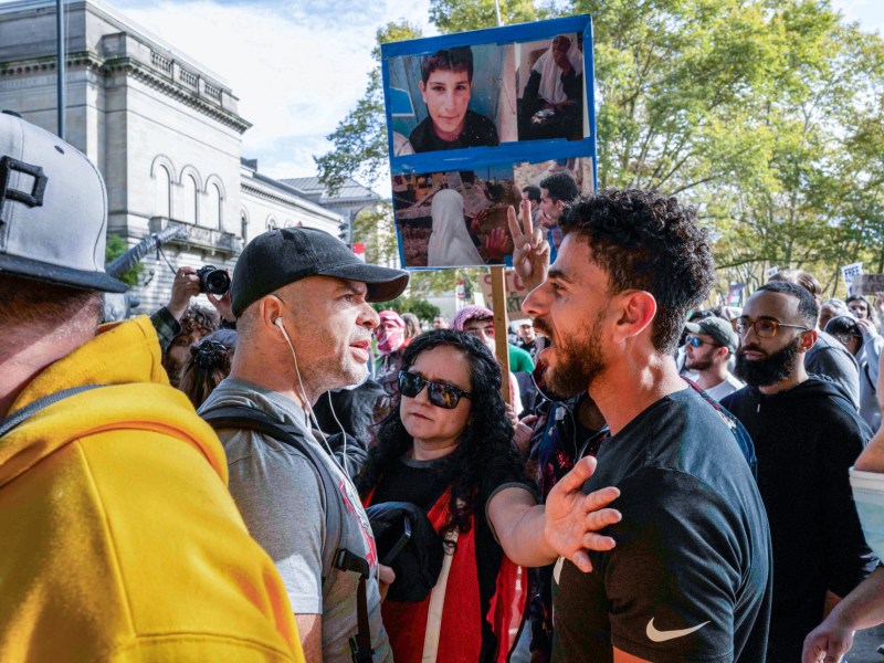 A counter-protestor (left) is blocked as he attempts to disrupt a rally in support of Palestine at Schenley Plaza in Oakland on Friday, October 13, 2023. (Photo by Quinn Glabicki/PublicSource)