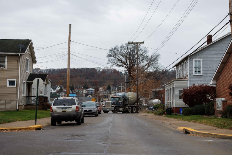 a concrete truck drives through a residential neighborhood.