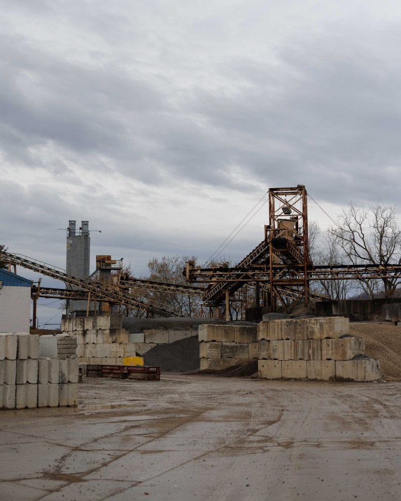 Old machinery stands over a concrete batch plant yard.