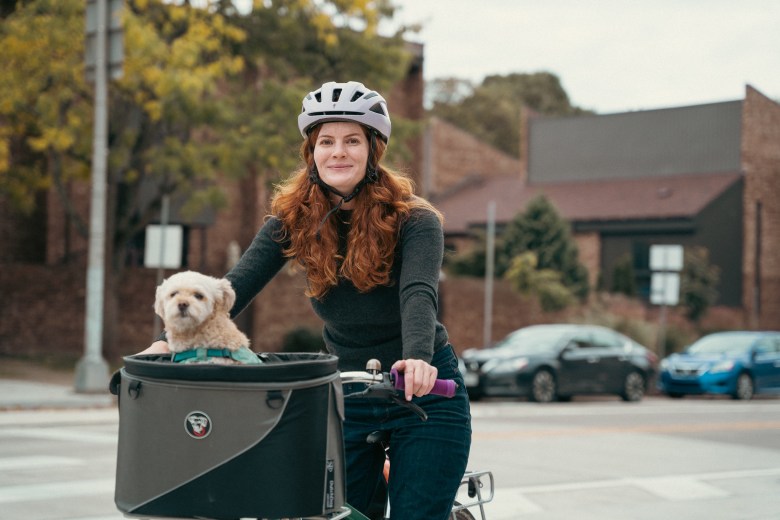 Morgan O'Grady and her dog Cricket biking