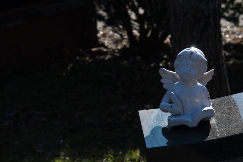 A small angel statue in front of a church